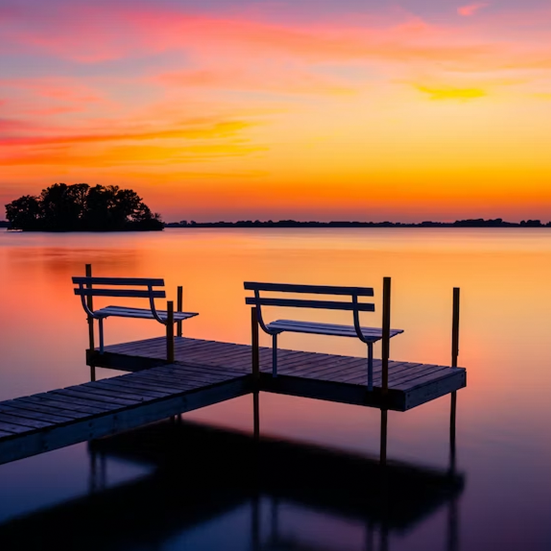 Dock with bench at sunset