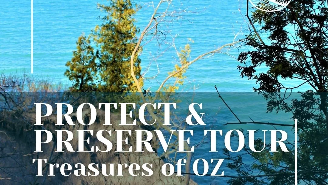 Lake behind a wooded hill with text that reads "Protect and Preserve Tour: Treasures of Oz"