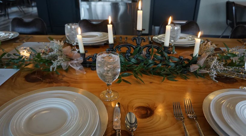 A table set for dinner with plates and candles.