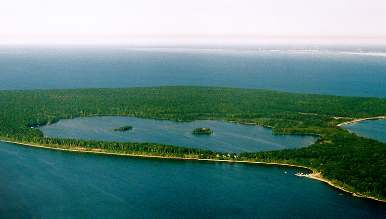 Aerial view of a lake surrounded by lake and a larger lake.