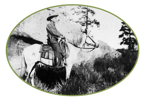 An old black and white photo of Aldo Leopold on horseback.