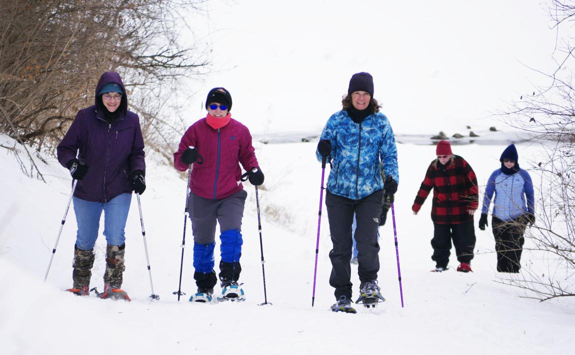 Five people snowshoeing on a trail in Wisconsin.