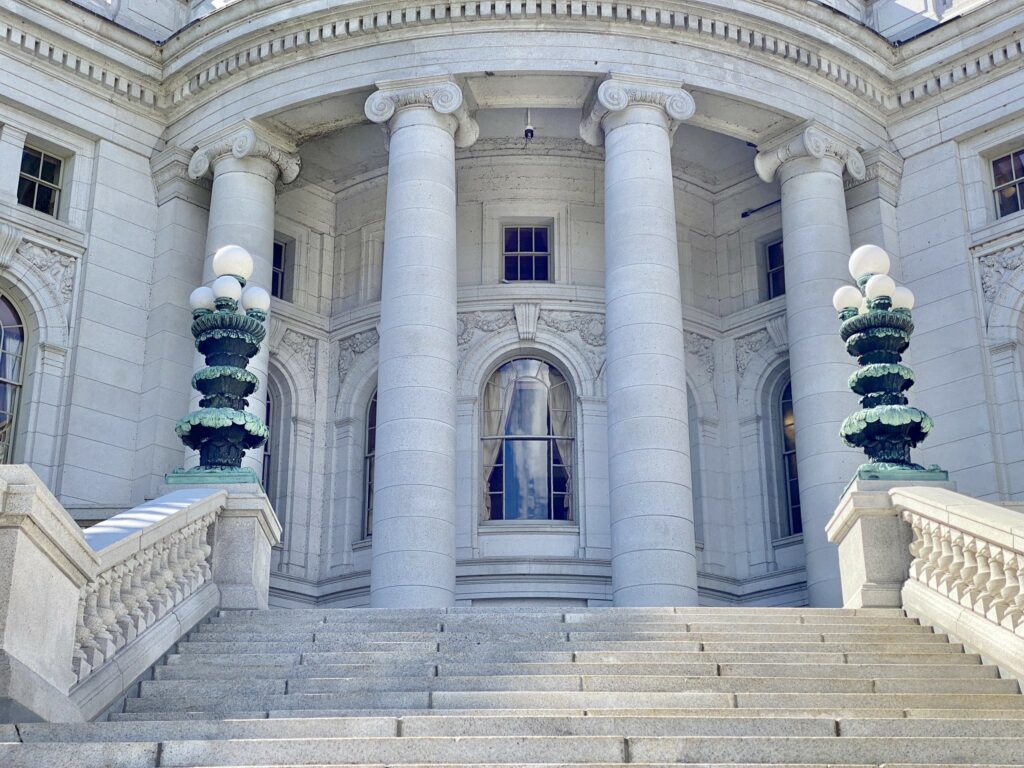 The white marble steps and pillars of the Wisconsin State Capitol building.