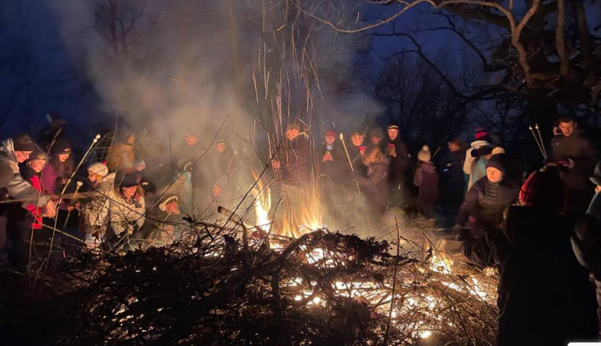 People at a large bonfire