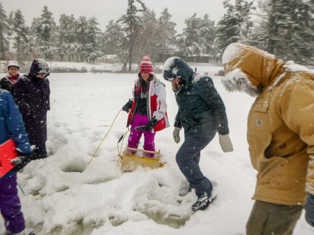 People having fun in the snow outside.