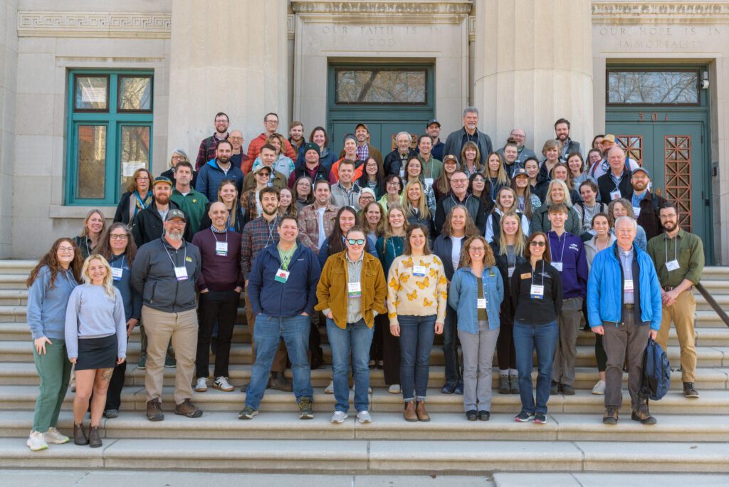 A big group of people standing outside in front of a building.