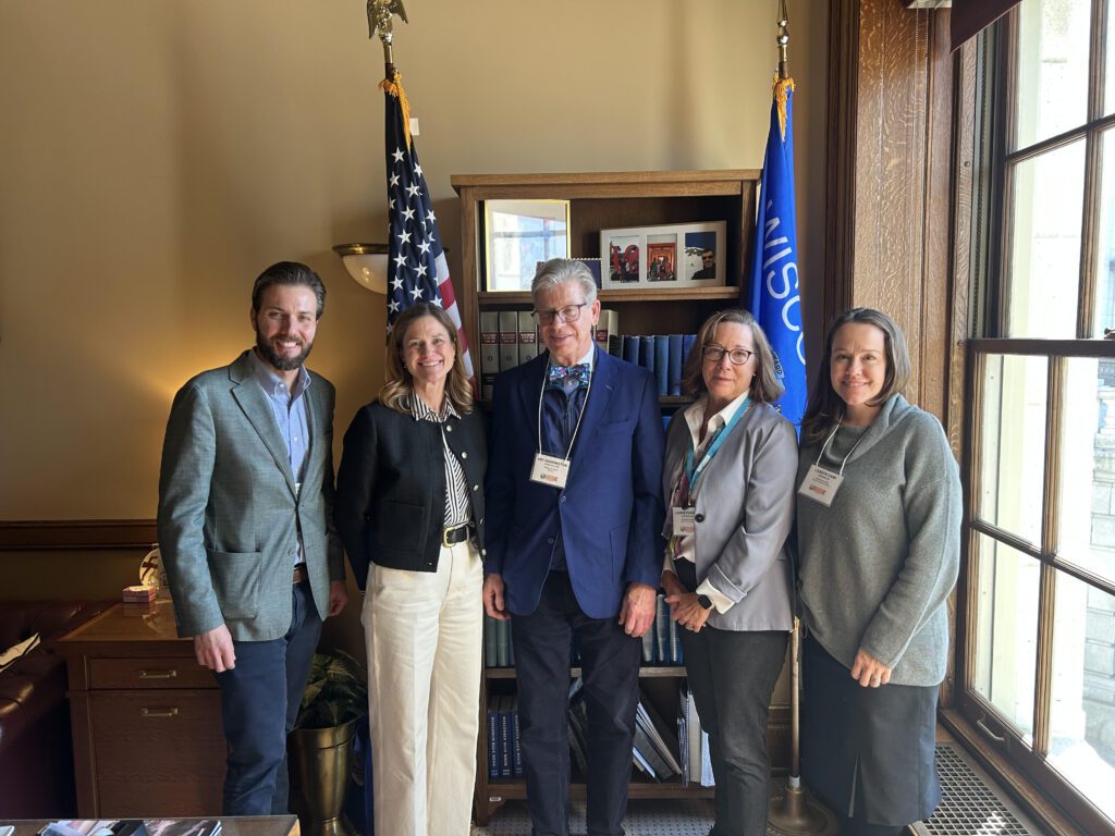 Five people standing together in an office at the Wisconsin State Capitol.